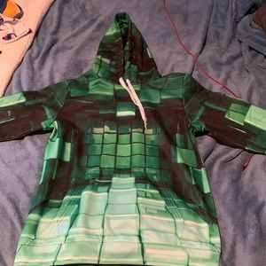 Green optical allusion sweater